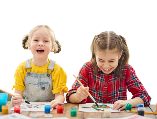 Two young children painting at a classroom table